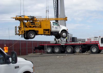 Loading a drill rig onto a barge for over-the-water drilling.