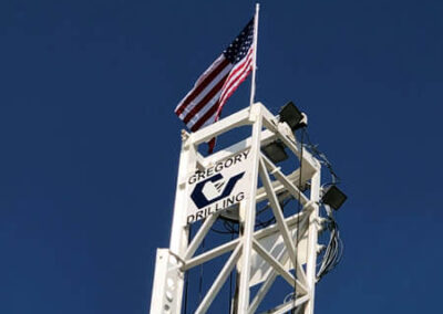 Drill rig mast with an American flag