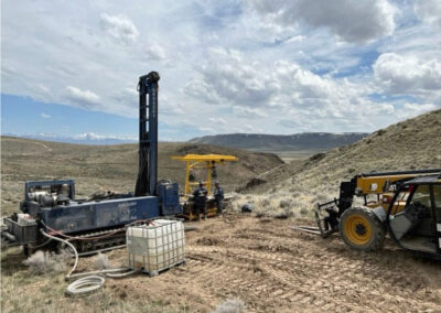 Lithium exploration drilling site: Sonic drill rig, water tank, crew, and support equipment.